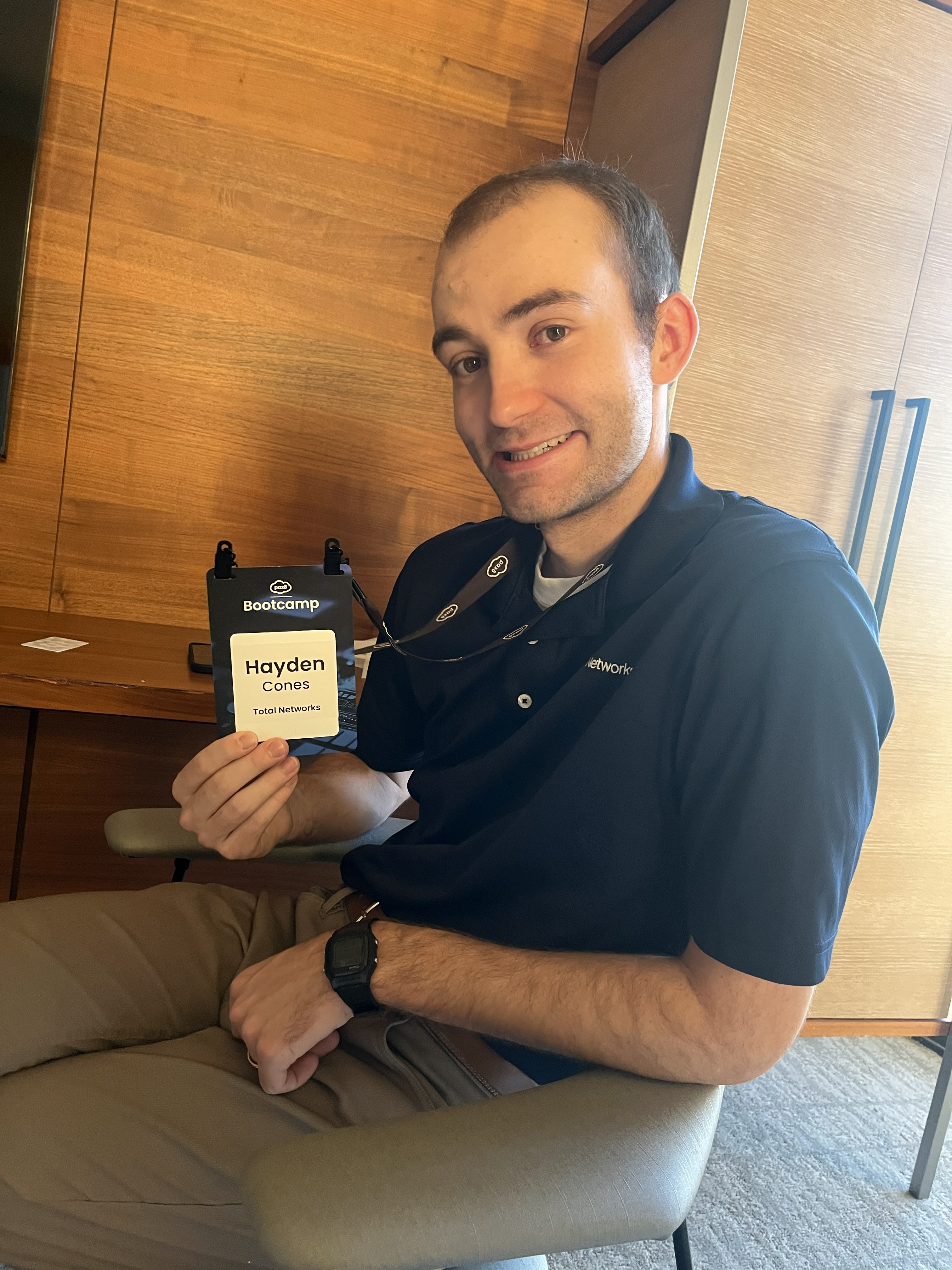 Holding a badge from the IT Conference